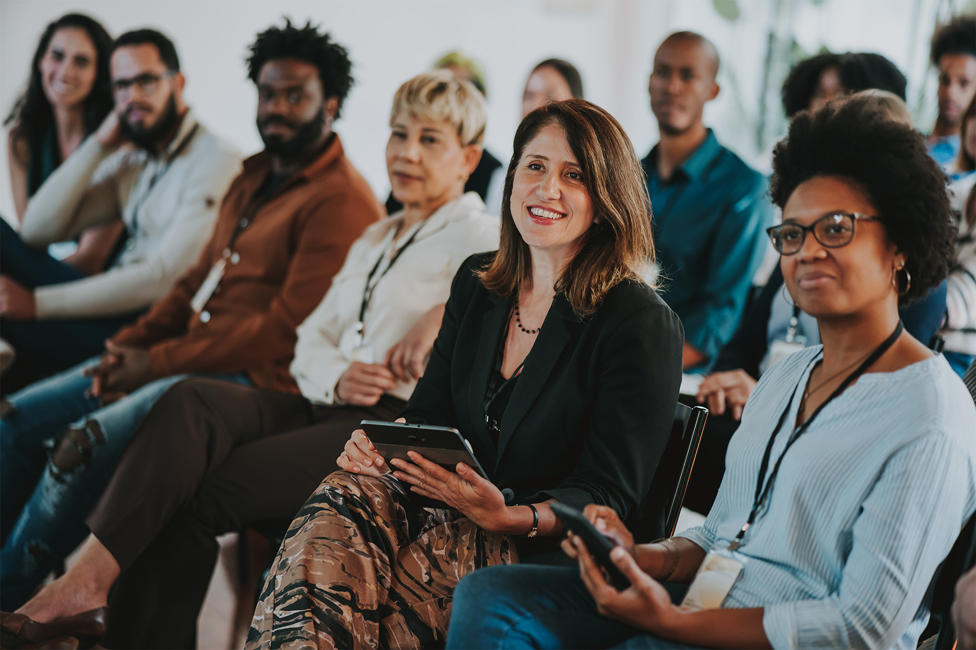 diverse group of adults in classroom smiling together